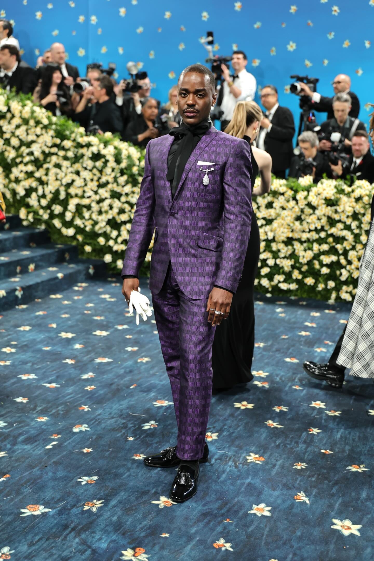 May be an image of 2 people, suit, dinner jacket, carpet and text May be an image of 2 people, suit, dinner jacket, carpet and text