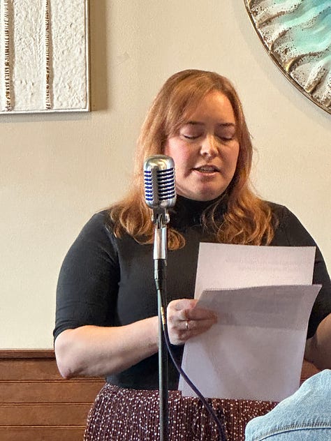 Candice reading her poems in front of an audience.