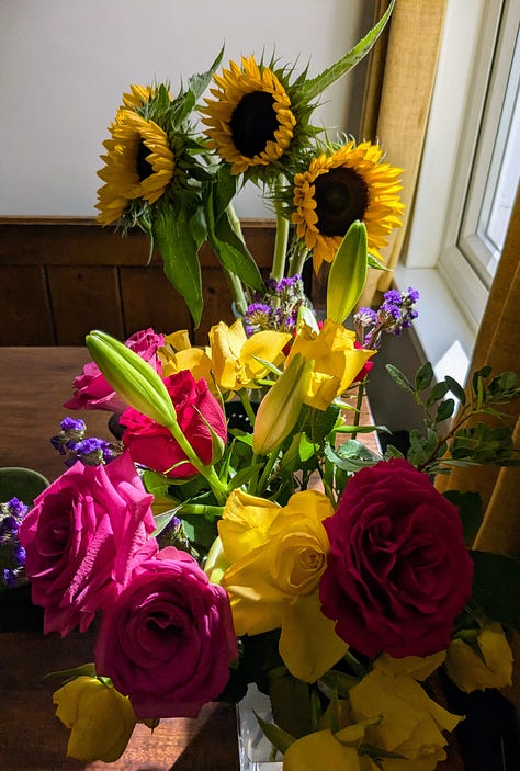 Photos of 2 greetings cards and bunches of flowers given to congratulate on the Adukeh the Poet's book launch