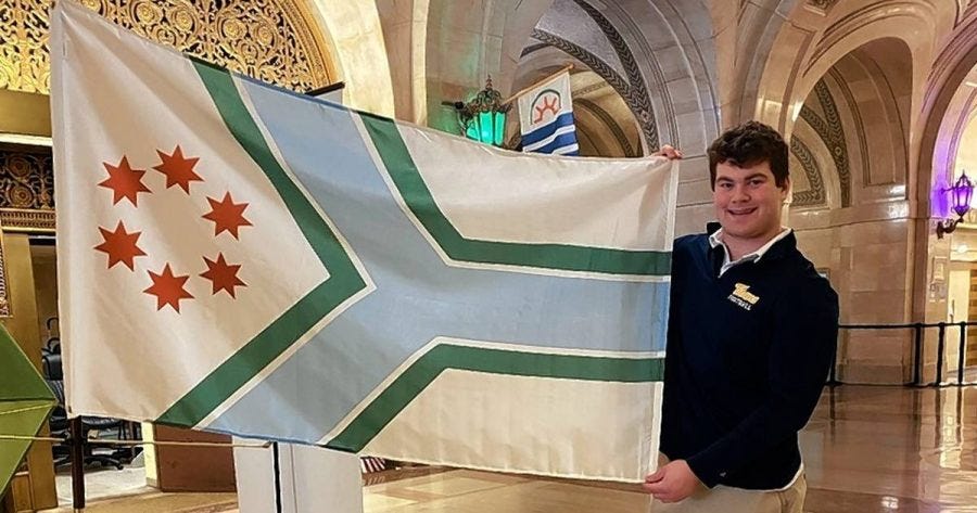 Duffy holds up his designed flag for Cook County. Photo courtesy of The Daily Herald.