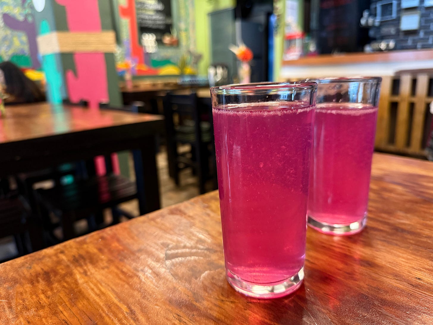 2 glasses of pink prickly pear aguas frescas on a table in Mexico City