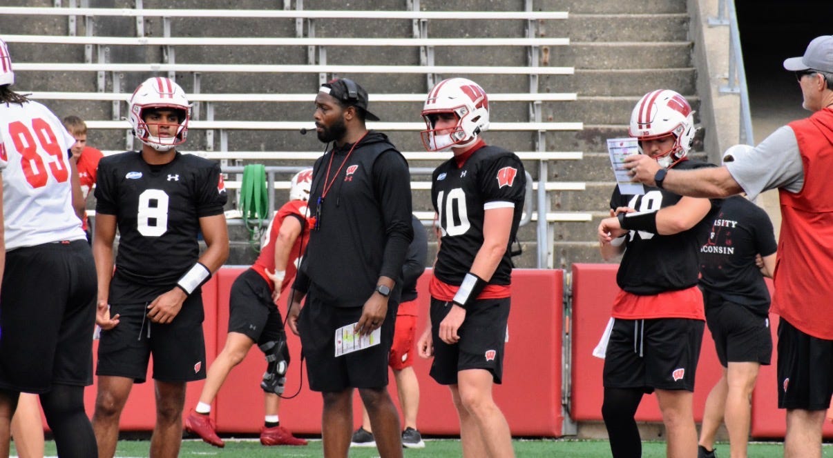 Wisconsin Badgers assistant coach Kenny Guiton stands with the quarterback room during fall camp practice.