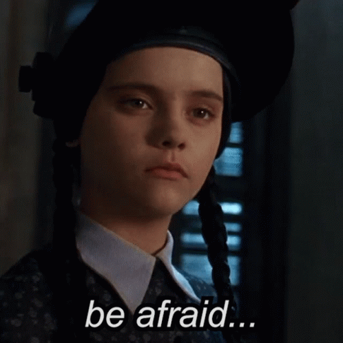 a girl with pigtails is wearing a hat and says be afraid . a girl with pigtails is wearing a hat and says be afraid .
