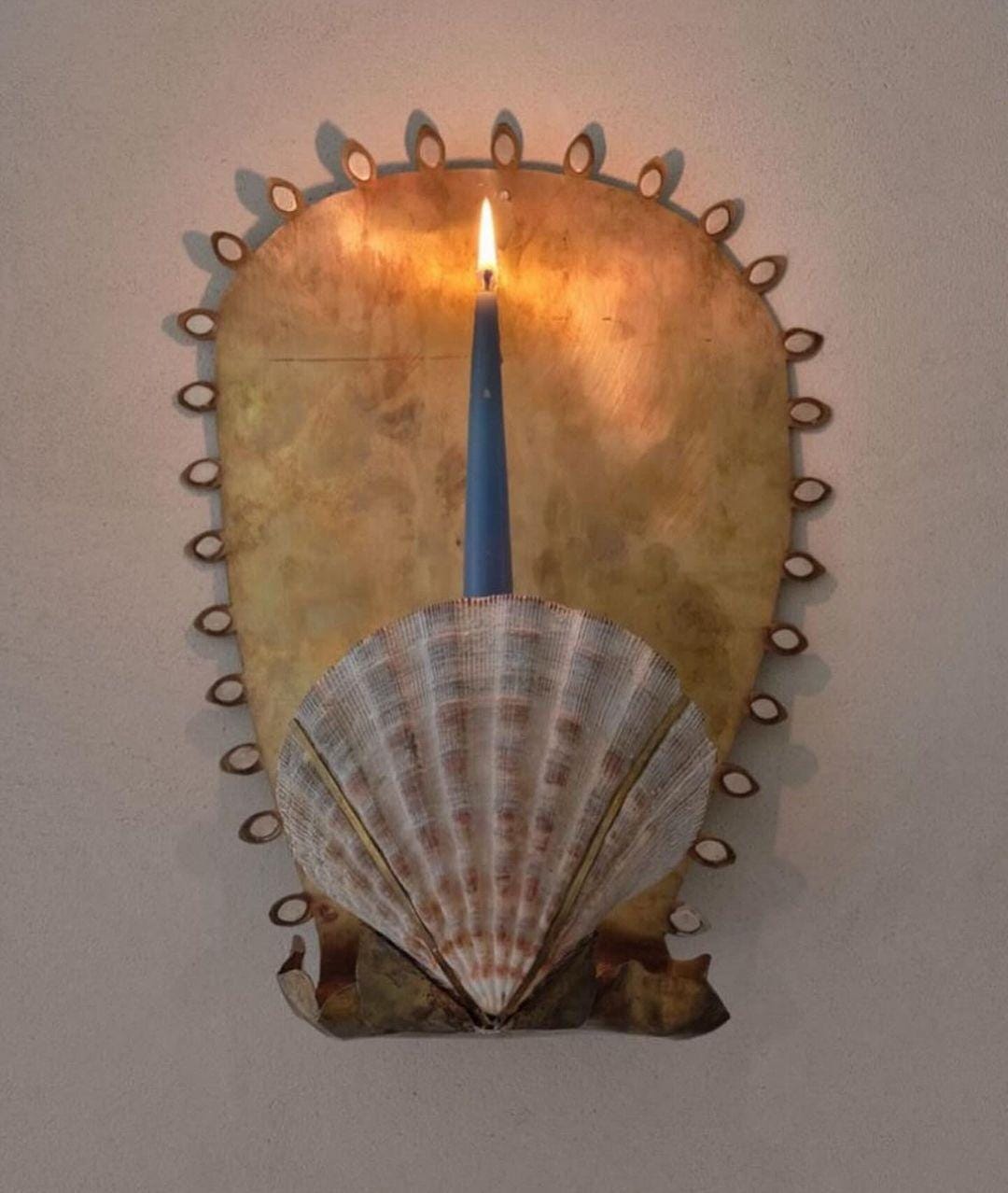An Instagram  post added by dailymusings on Apr 18, 2024. The author is @objet_la_ny. May present: shell, candle, wood, art.