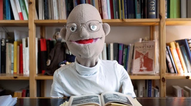 a YouTube still showing a muppet version of Michel Foucault