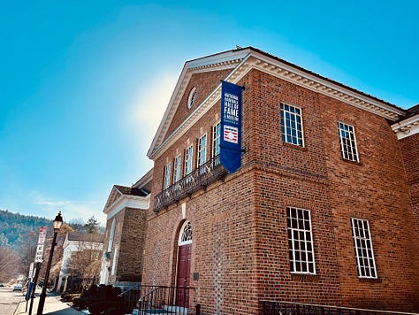 building, statues, doors, sky, street, pavement