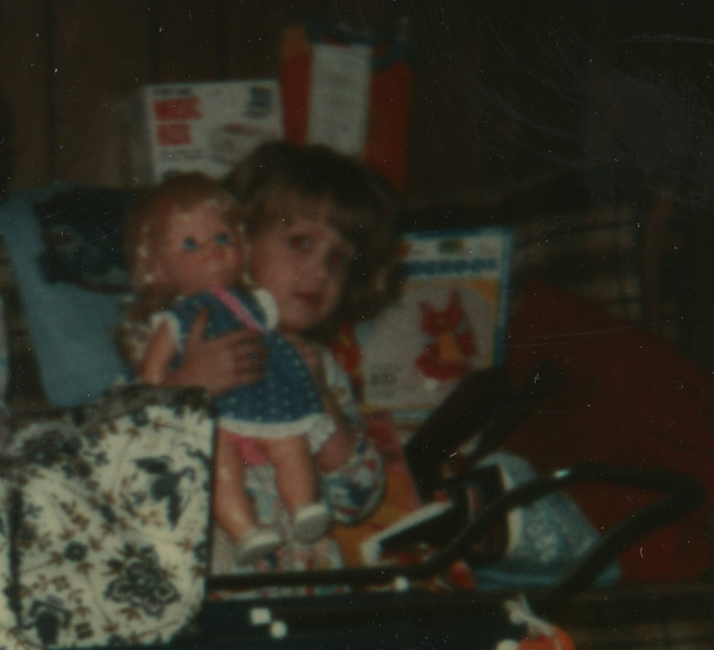 loseup of Karrie's face from the first photo; the little child looks unhappy and maybe a little frightened.