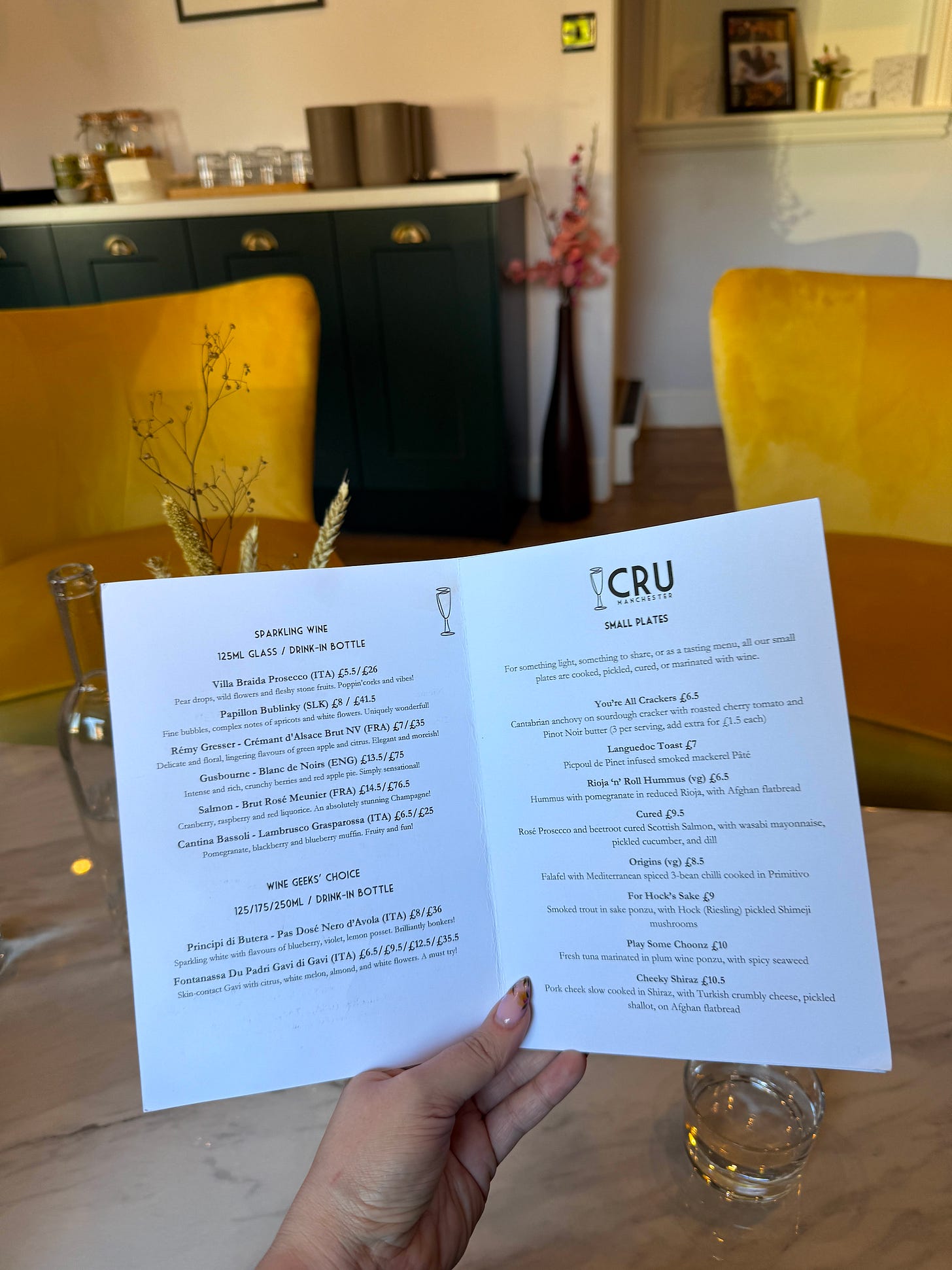 A person holding a menu at new wine bar Cru Didsbury