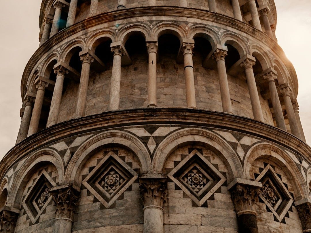 brown concrete tower under white clouds during daytime