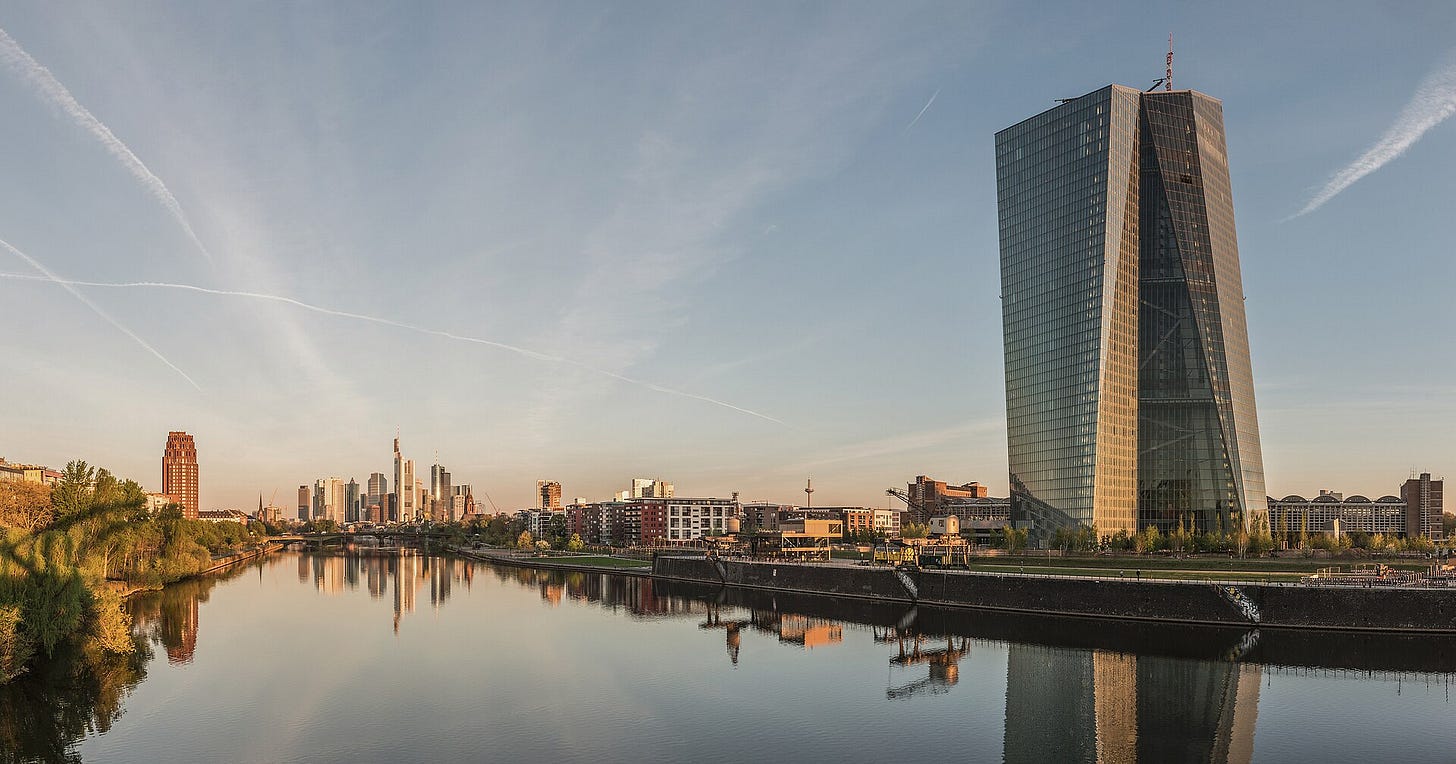 European Central Bank tower in Frankfurt at dawn, reflected in the river Main