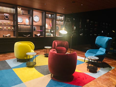 A series of nine photos inside the new library at MONA art museum shows shelves of books, reading lounges, cheeky covers, artist books, globes and more.