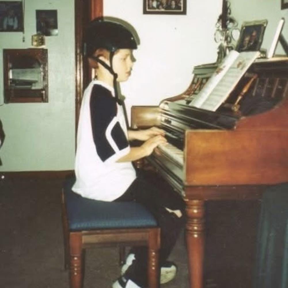 May be an image of 1 person and piano