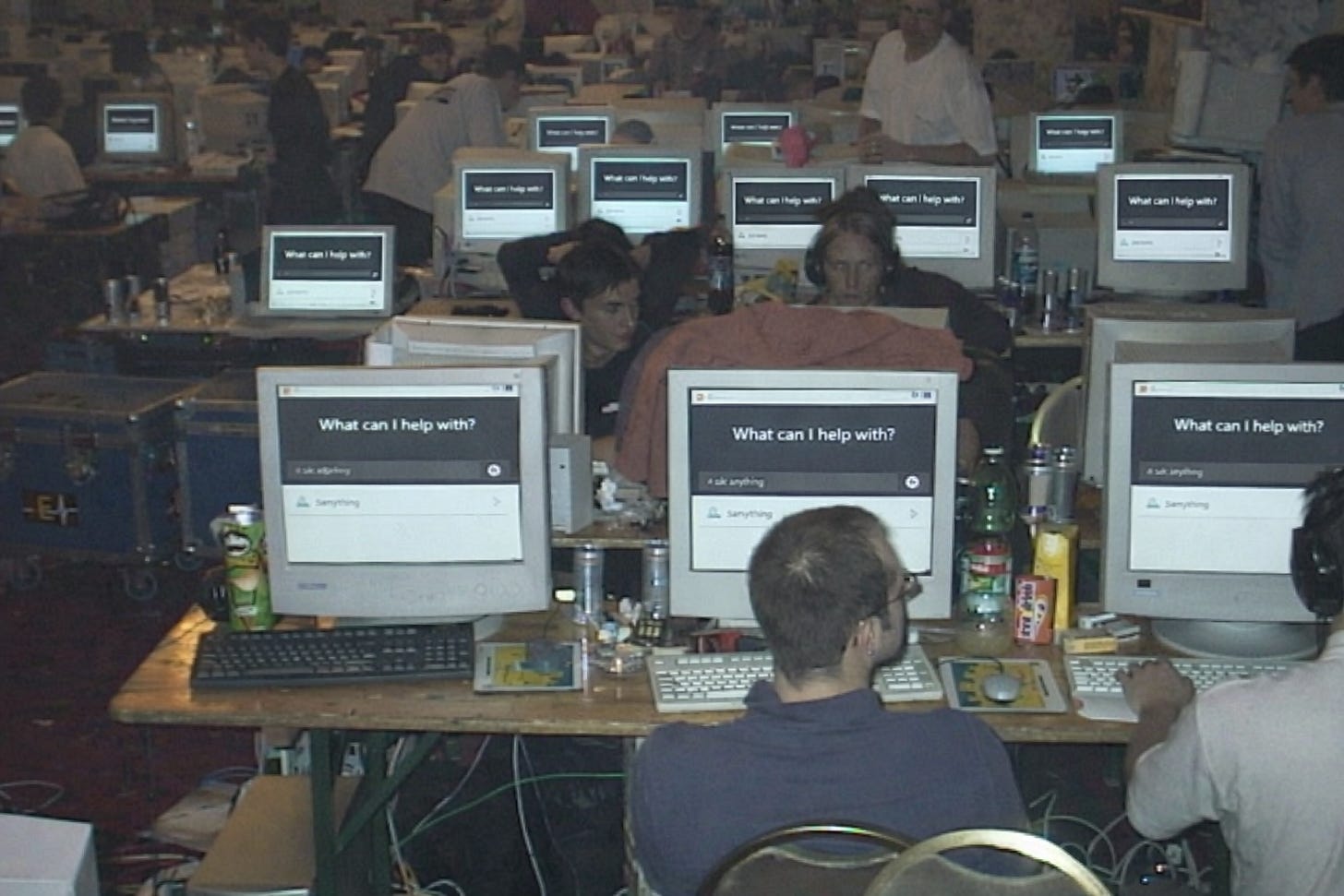 Early internet-era computer lab filled with users, illustrating the early-stage mass adoption phase of consumer AI tools.