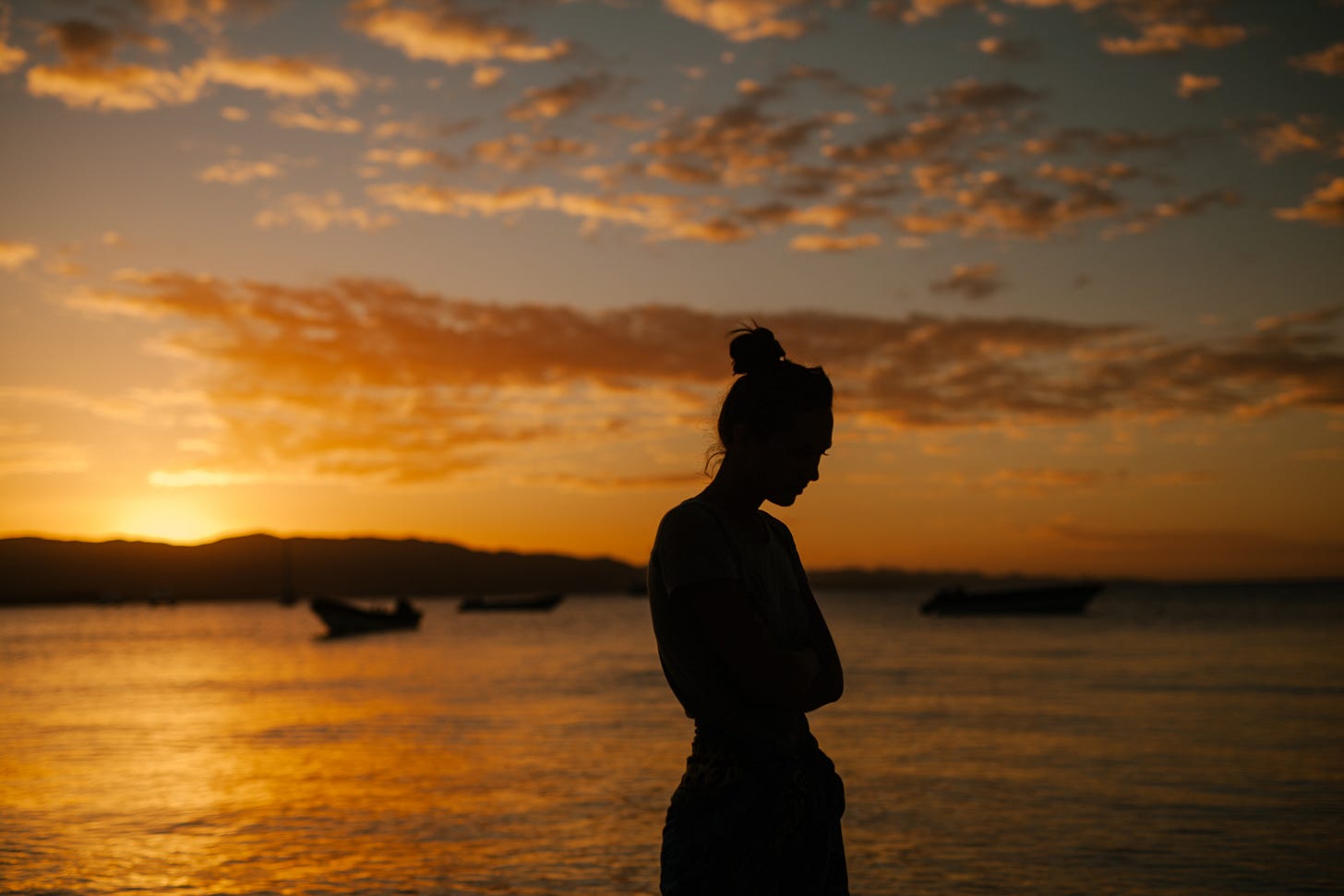 A woman standing on the coast of the sea. A woman standing on the coast of the sea.