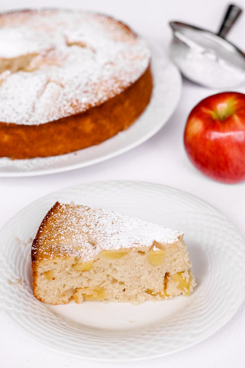 close up image of a slice of Italian apple cake on a white plate. 