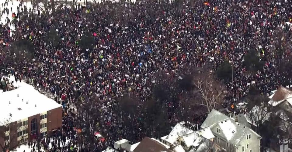 Aerial view of a massive crowd gathered in winter conditions for a protest in Minneapolis.