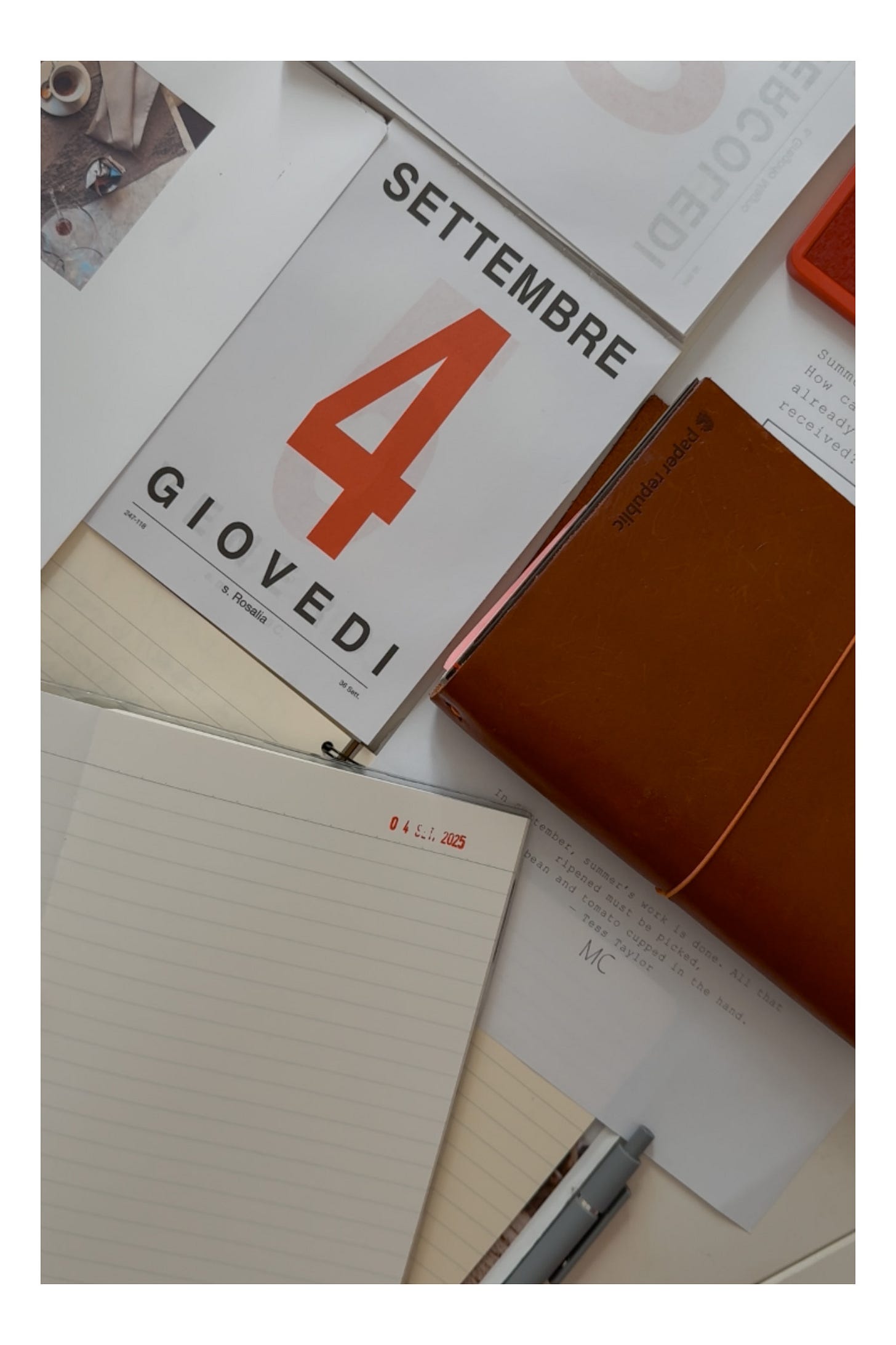 Writerly desk with Italian calendar page, open notebook, and journal — photo by Michelle Ciani