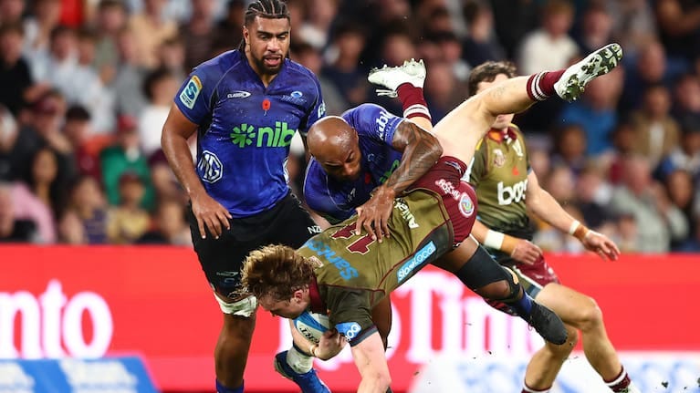 Tim Ryan of the Reds is tackled by Mark Tele'a of the Blues duringthe round 11 Super Rugby Pacific match between Queensland Reds and Blues at Suncorp Stadium.
