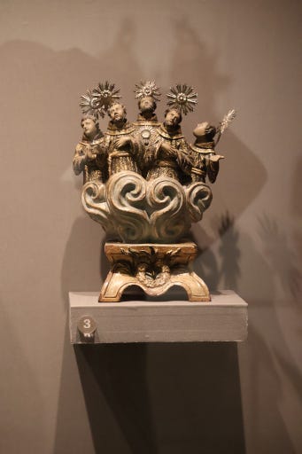 Photo of reliquary with small sculptures of five monks