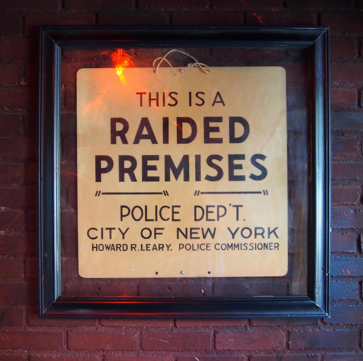 The original 'Raided Premises' sign inside The Stonewall Inn The original 'Raided Premises' sign inside The Stonewall Inn