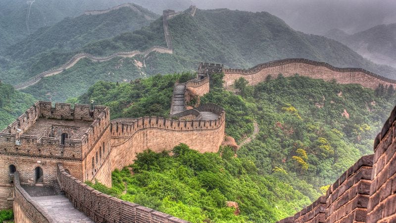 The Great Wall of China stretching across the mountains, symbolizing how walls built for protection can create false security. A historical lesson connected to investing moats, complacency, and the rise and fall of powerful empires and companies.
