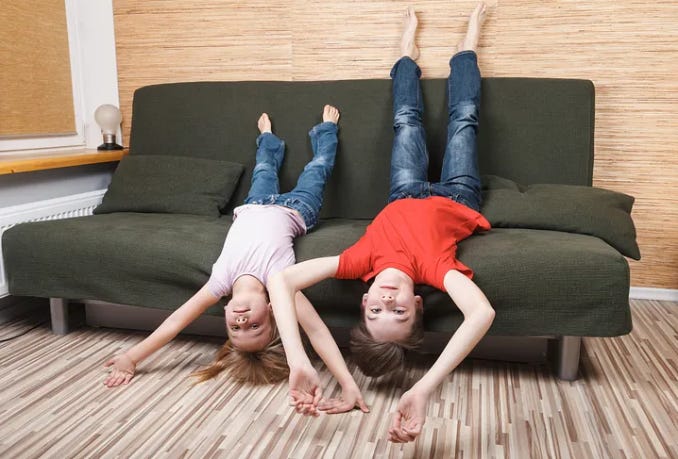 kids hanging upside down looking bored AF