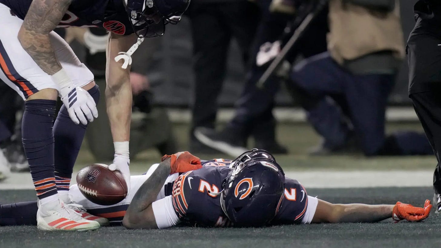 Chicago Bears wide receiver DJ Moore (2) lies on the turf after making the game-winning touchdown catch during overtime in their game Saturday, December 20, 2025 at Soldier Field in Chicago, Illinois. The Chicago Bears beat the Green Bay Packers 22-16 in overtime.