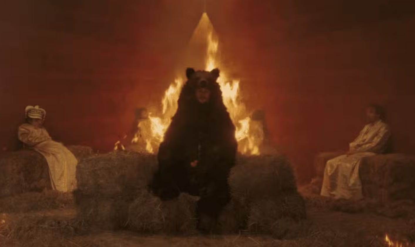 scene of a human sacrifice from the end of Midsommar, featuring a dude in a bear suit about to be burned alive scene of a human sacrifice from the end of Midsommar, featuring a dude in a bear suit about to be burned alive