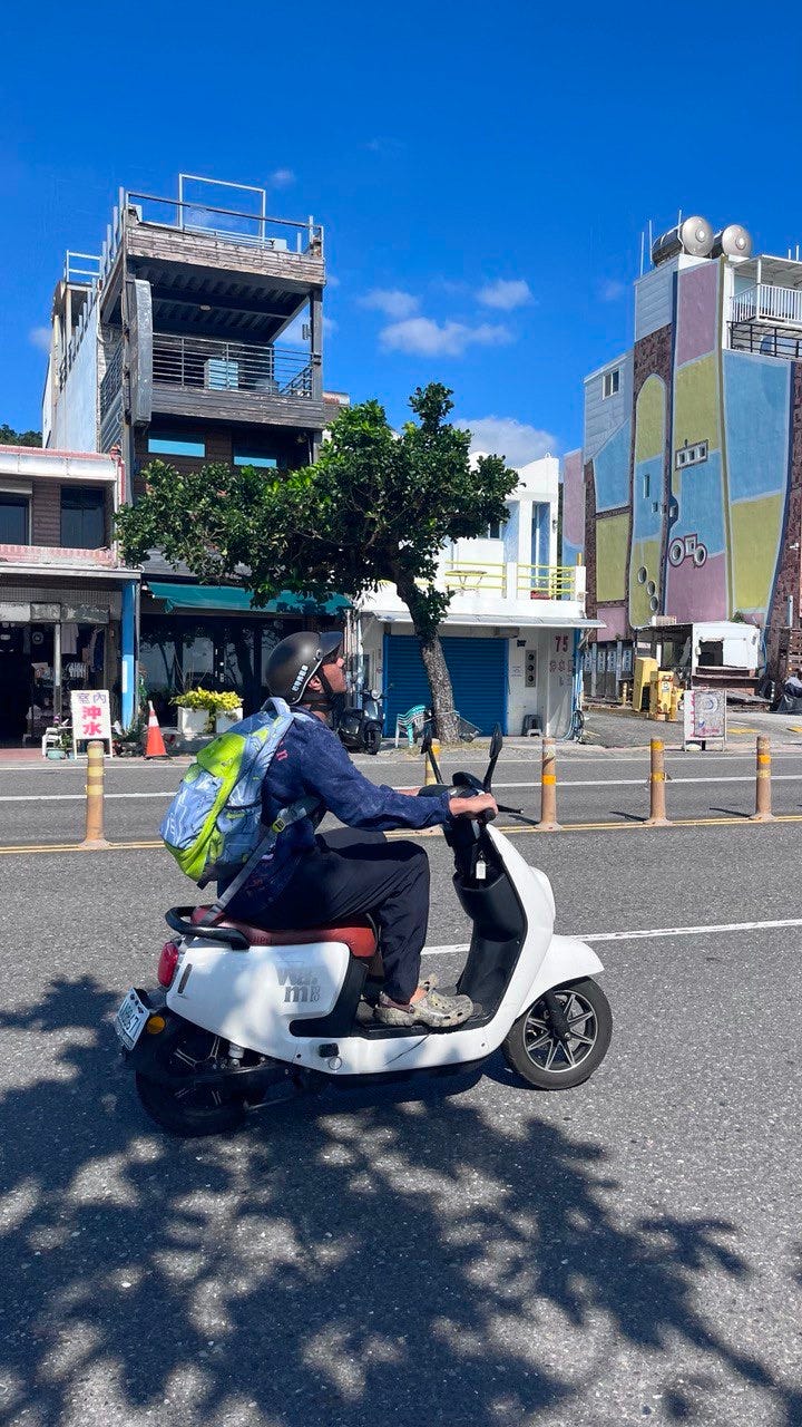 A person riding a scooter

Description automatically generated