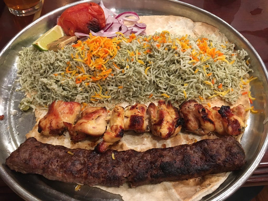 Chicken breast and lamb koubideh skewers with rice at Kabobi. Tomato, red onion, lime, and butter on the side Chicken breast and lamb koubideh skewers with rice at Kabobi. Tomato, red onion, lime, and butter on the side