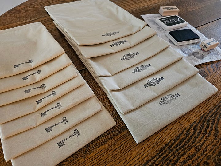 an array of drawstring bags and black ink stamps