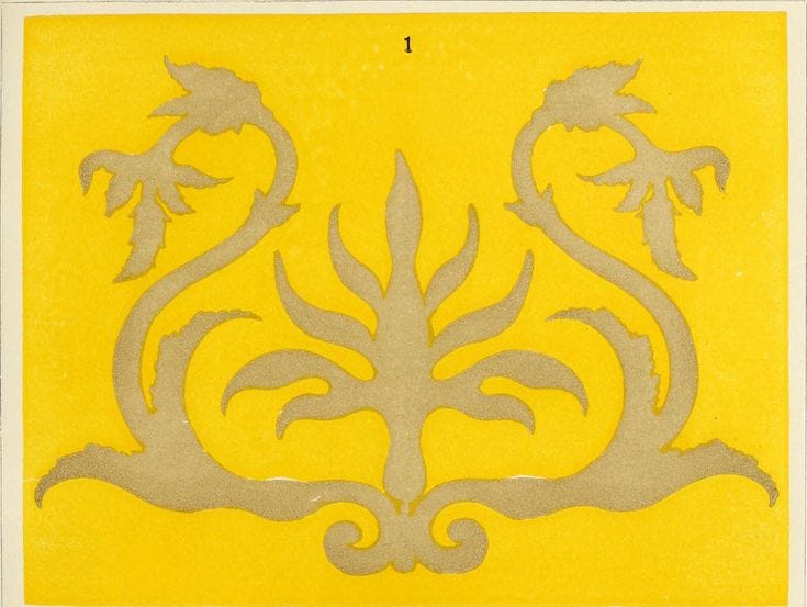 This may contain: a yellow tile with white designs on it