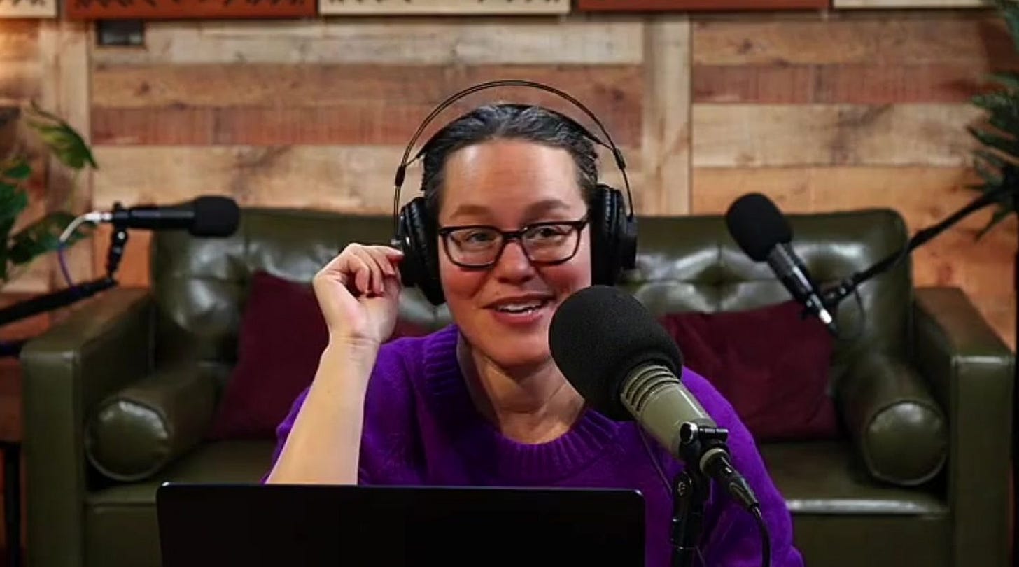 Maggie Hoffman in a purple sweater with microphone and headphones.