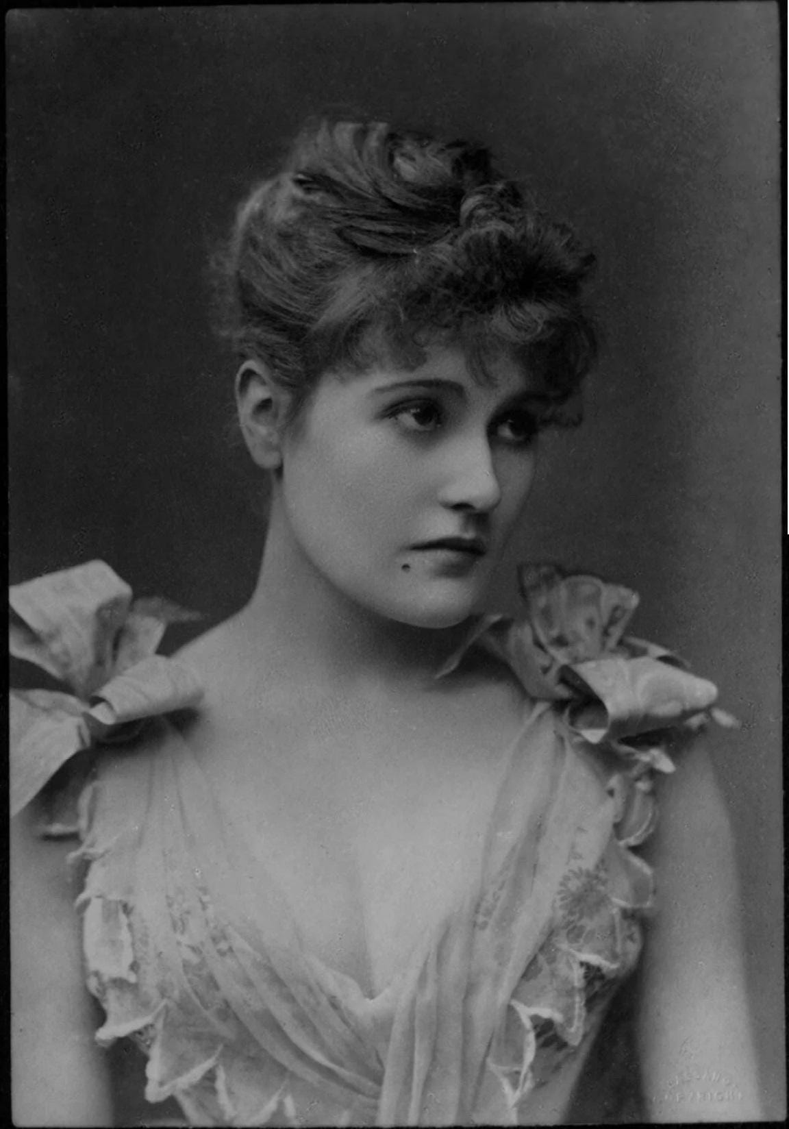 Actress Belle Bilton elegantly portrays 'the beauty' in the play 'Beauty and the Beast' in 1889, a glimpse into Victorian-era theatre.