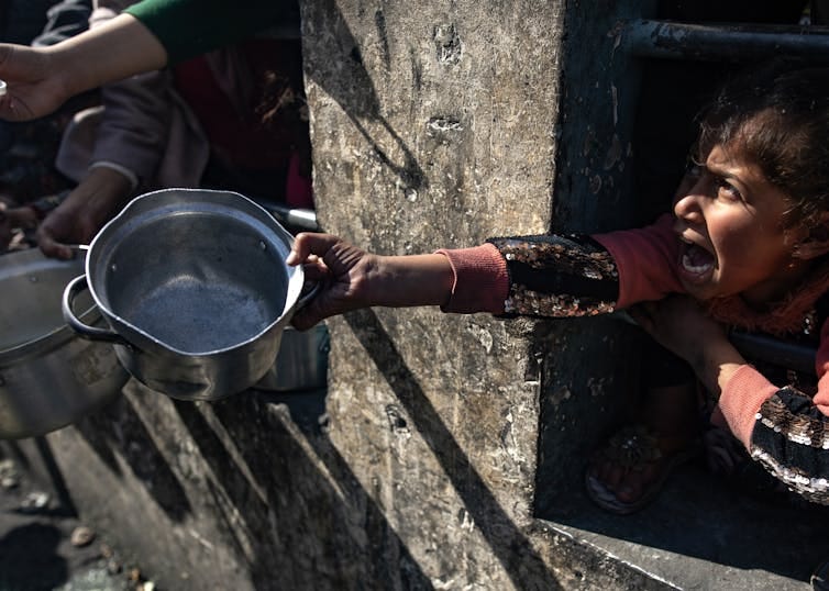 A Palestinian child waiting for food aid. A Palestinian child waiting for food aid.