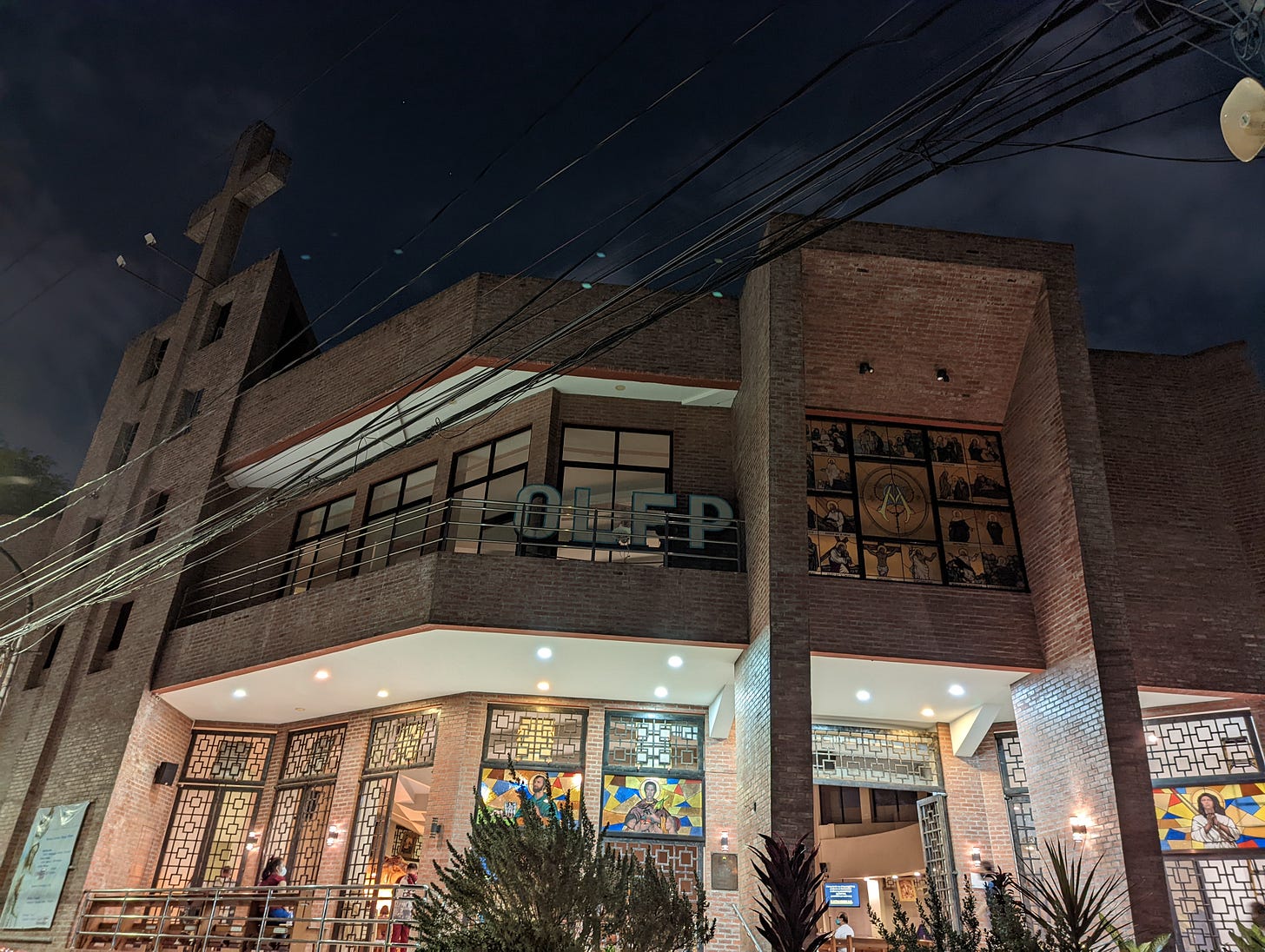 The exterior of Our Lady of Fatima Parish and its well-lit main entrance