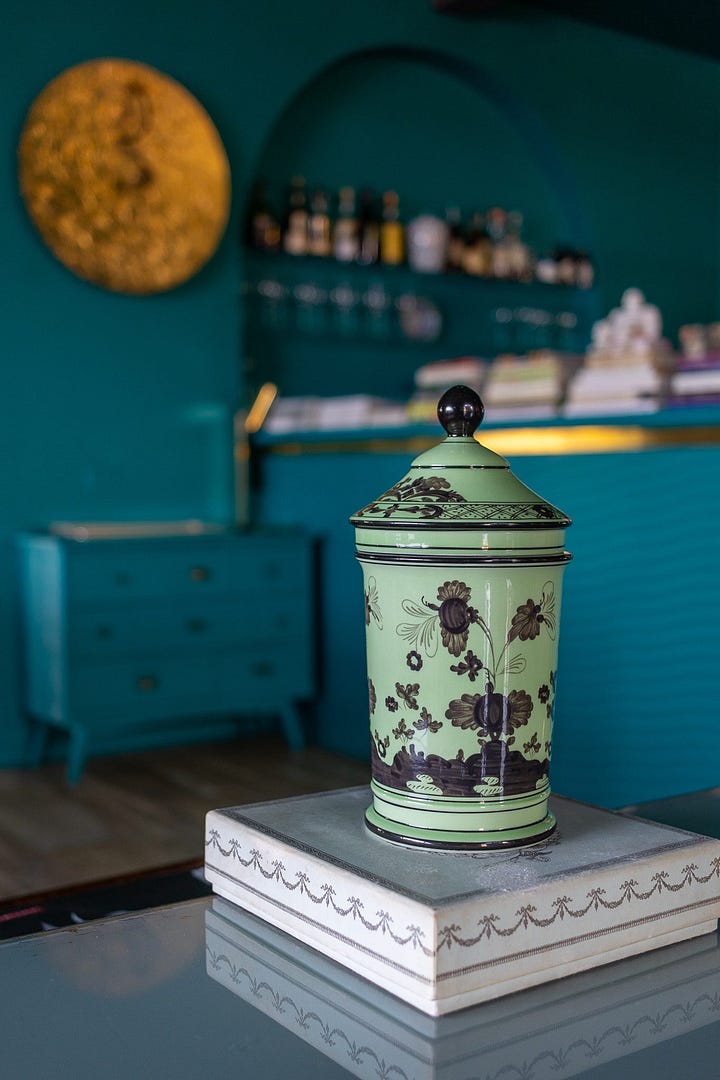 Lido 84's interior is bathed in a deep teal with eclectic Italian touches.