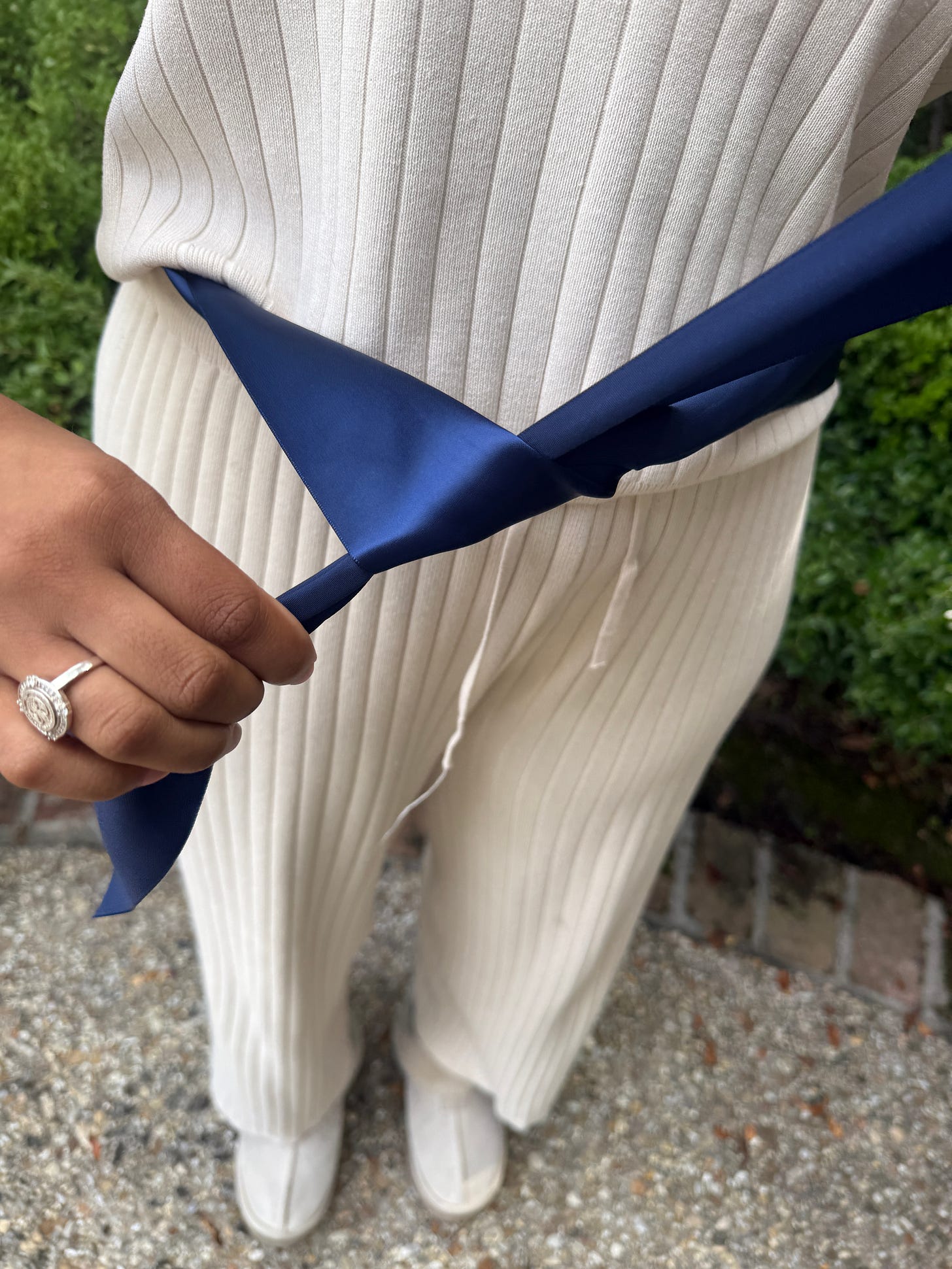 Creating the first loop with the bottom piece of navy ribbon