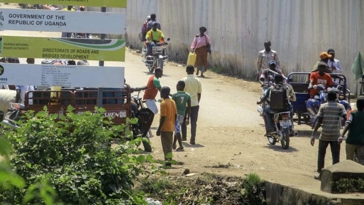 People walk along the street on the Ugandan side of the border crossing near Kasindi, eastern Congo Wednesday, June 12, 2019, just across from the Ugandan town of Bwera. People walk along the street on the Ugandan side of the border crossing near Kasindi, eastern Congo Wednesday, June 12, 2019, just across from the Ugandan town of Bwera.