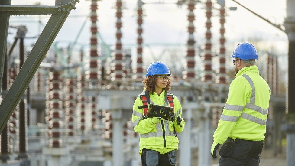 Workers at electricity substation Workers at electricity substation