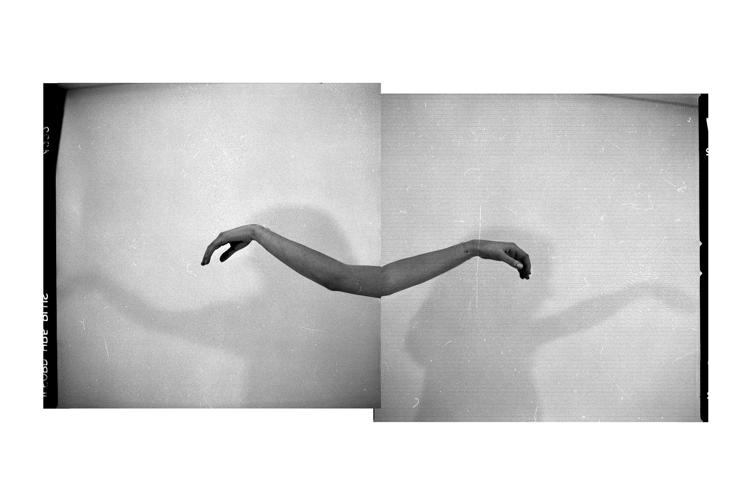 a mirror photo of two outstretched arms with silhouette shadow of a figure behind them a mirror photo of two outstretched arms with silhouette shadow of a figure behind them