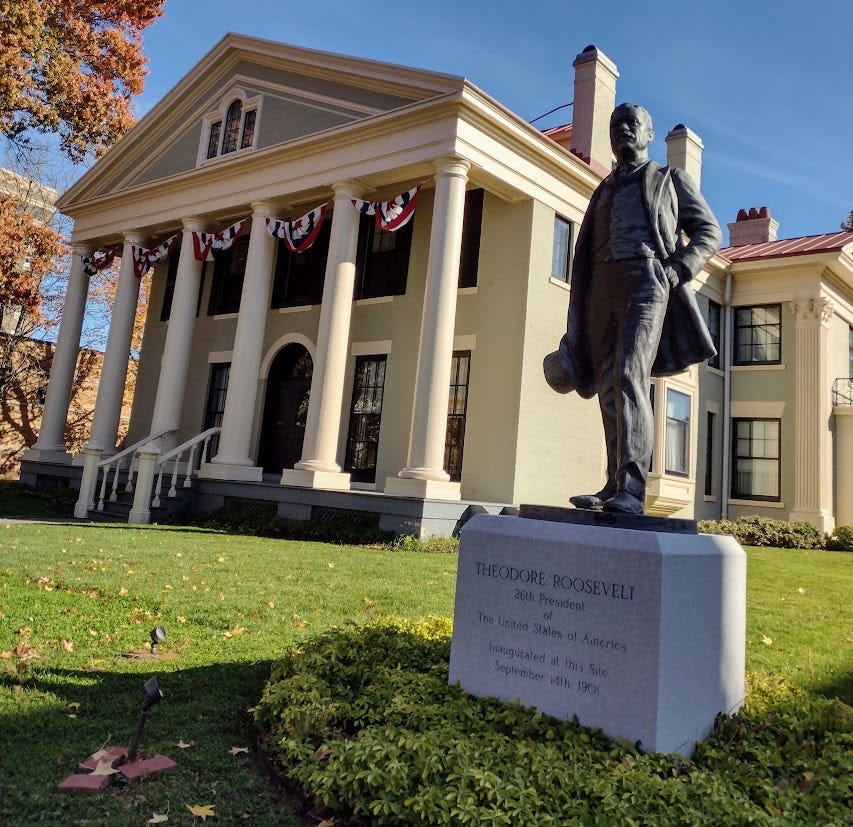 Theodore Roosevelt statue in front of neoclassical mansion Theodore Roosevelt statue in front of neoclassical mansion