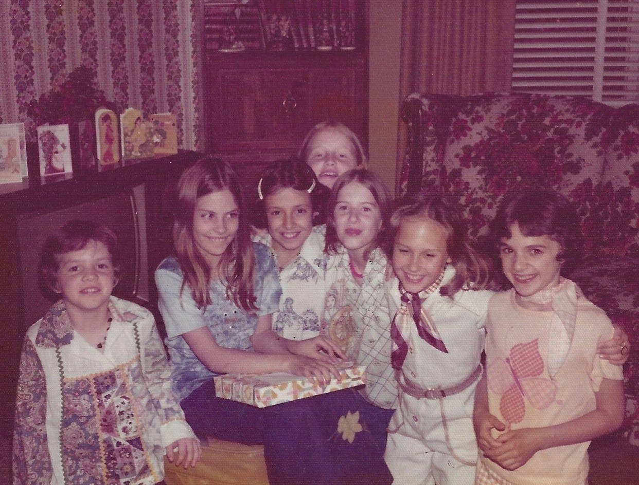 10-year-old girl is about to open her birthday presents in front of six of her girlfriends