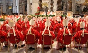 Meanwhile, back in the living room, one of the cardinals reads out the next task 