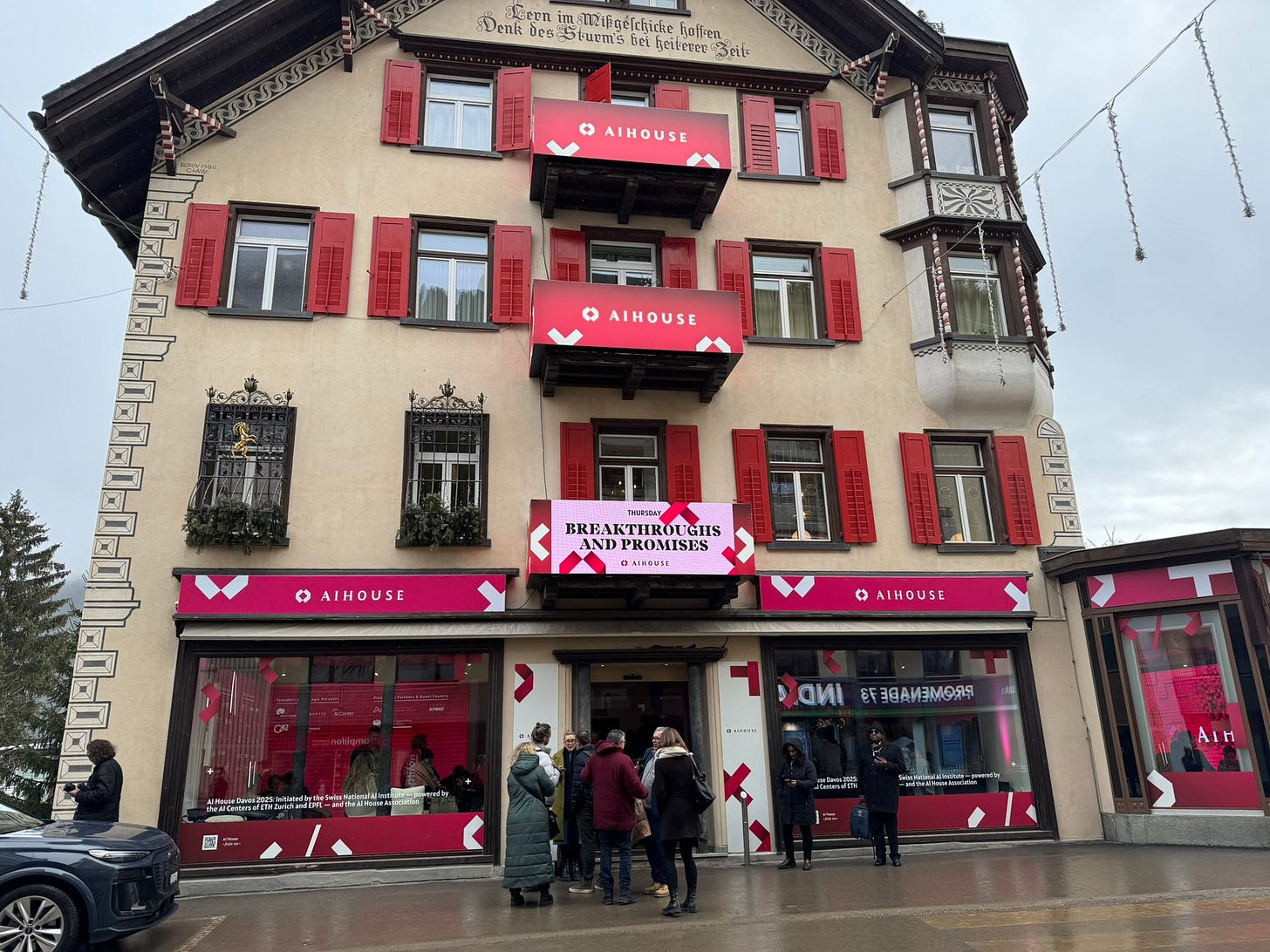 A hotel turned into an event venue with signs posted saying "AI House" in bright pink