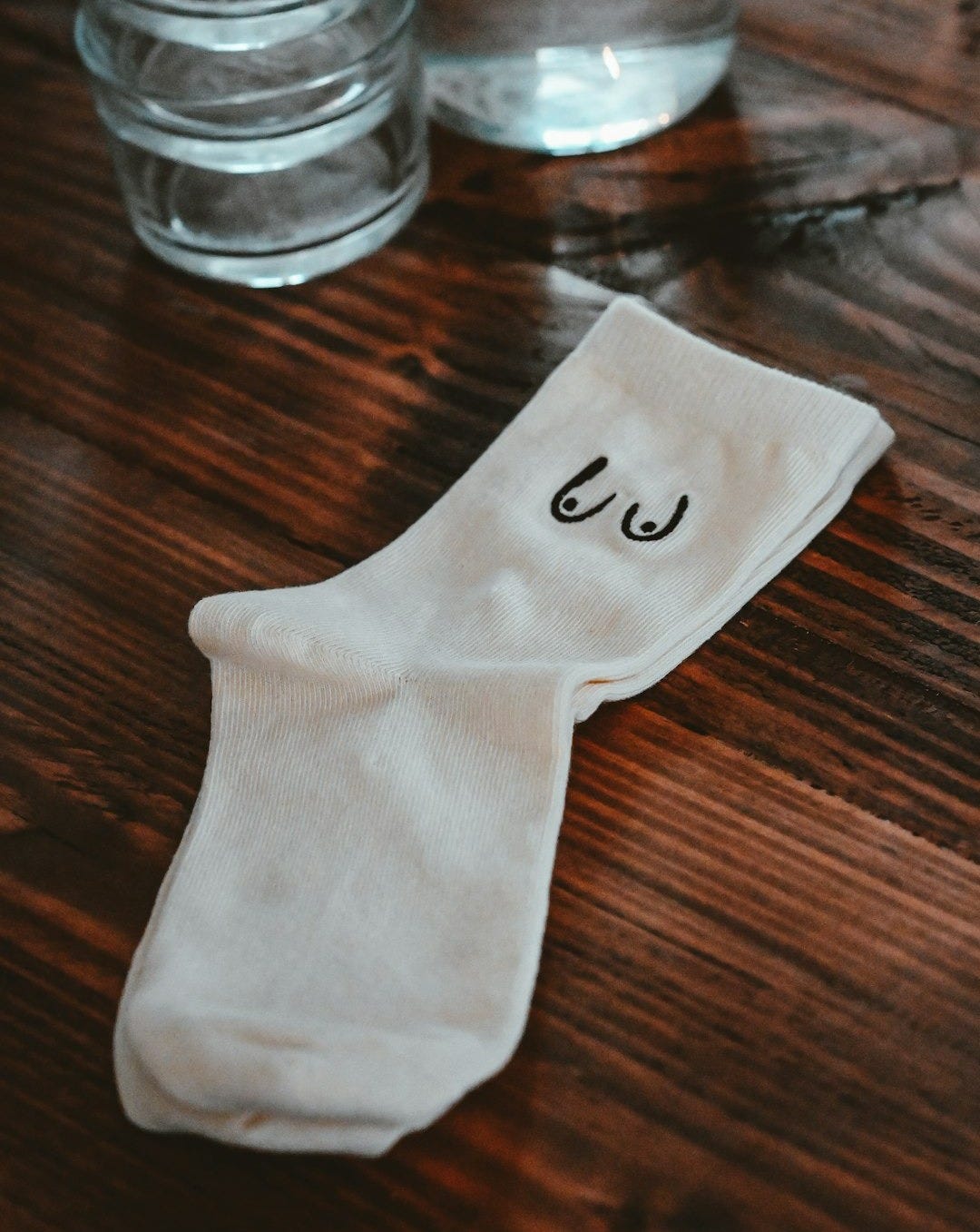 a pair of socks sitting on top of a wooden table