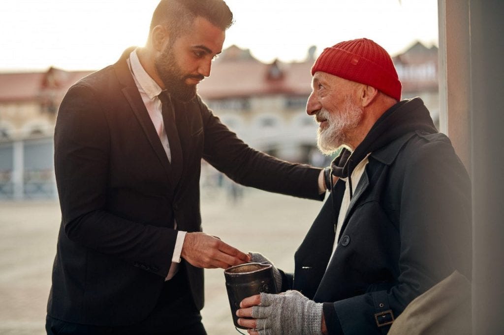 young man helping a homeless