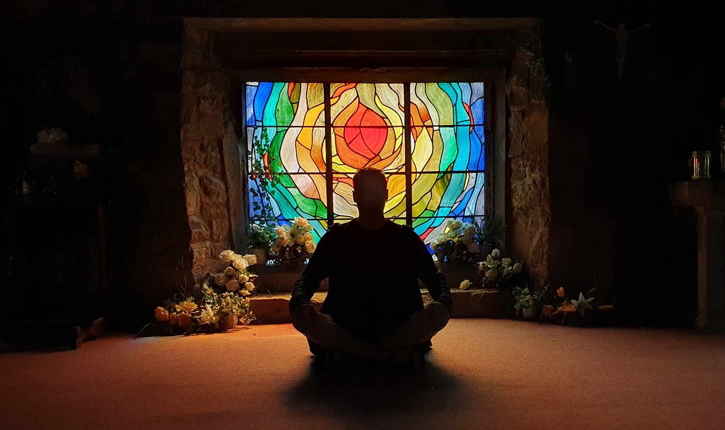 A photo of me sitting in front of a stainedglass window A photo of me sitting in front of a stainedglass window