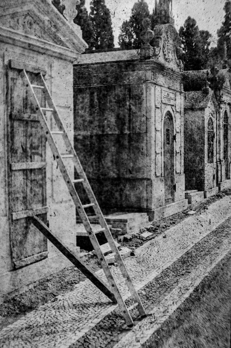 black and white film photograph of a ladder keeping a tomb's door closed