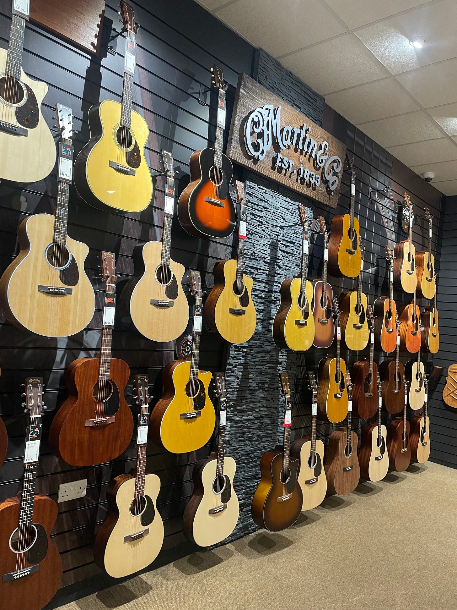A wall of acoustic guitars